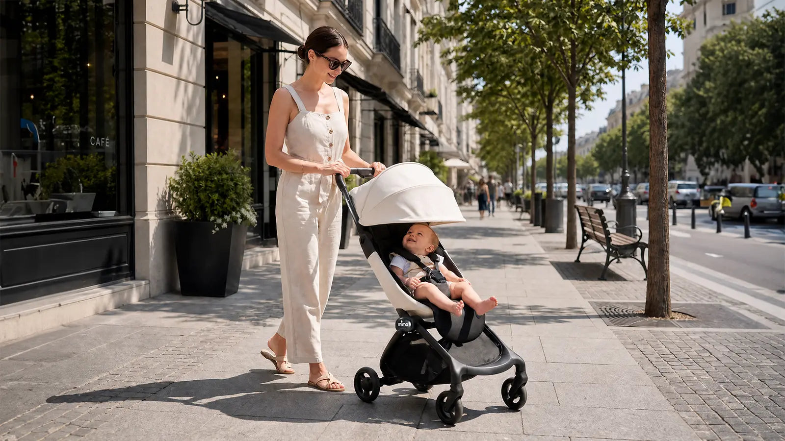 Parent walking in the city with a mima stroller