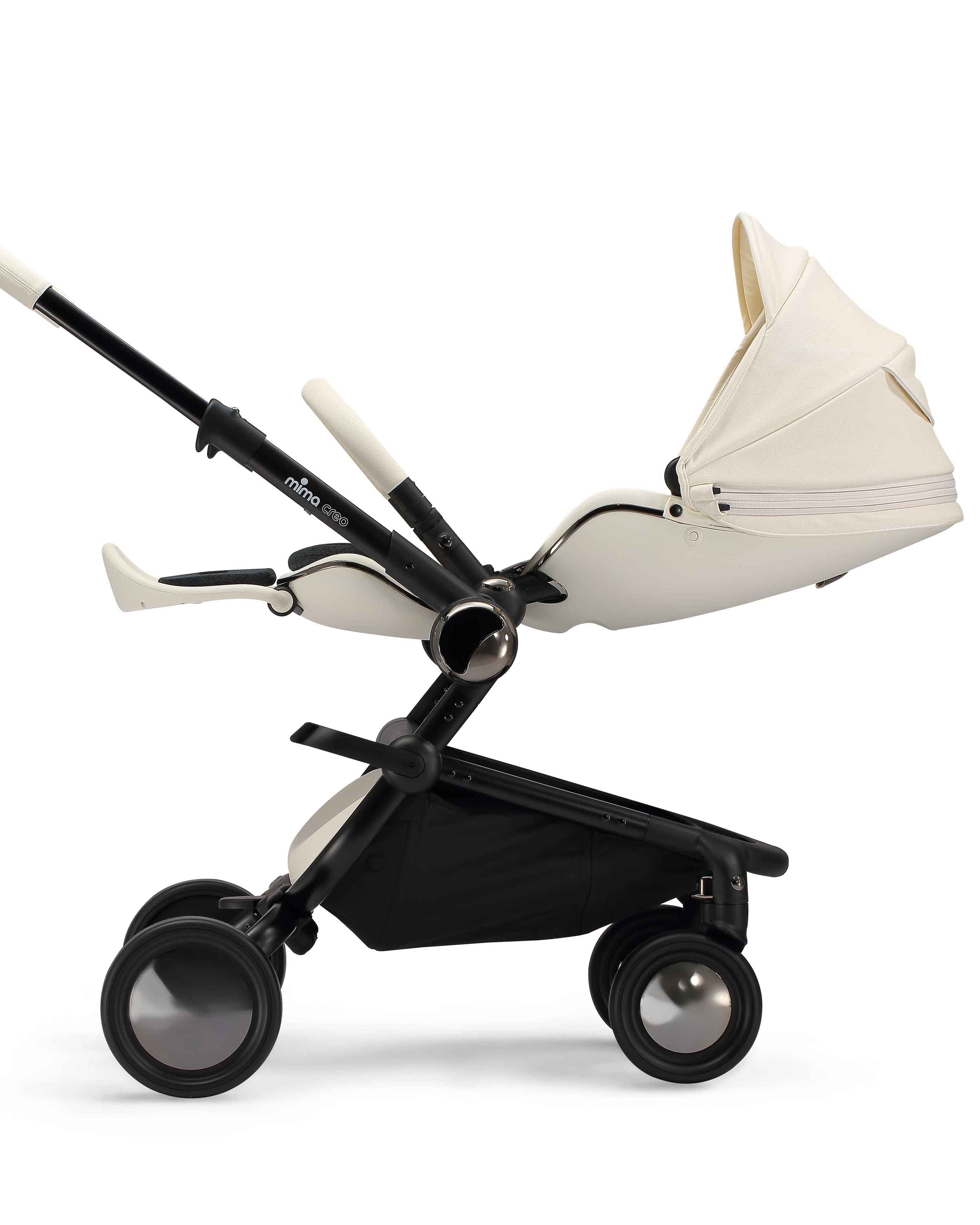 side view of parent facing fully reclined mima creo compact stroller in white