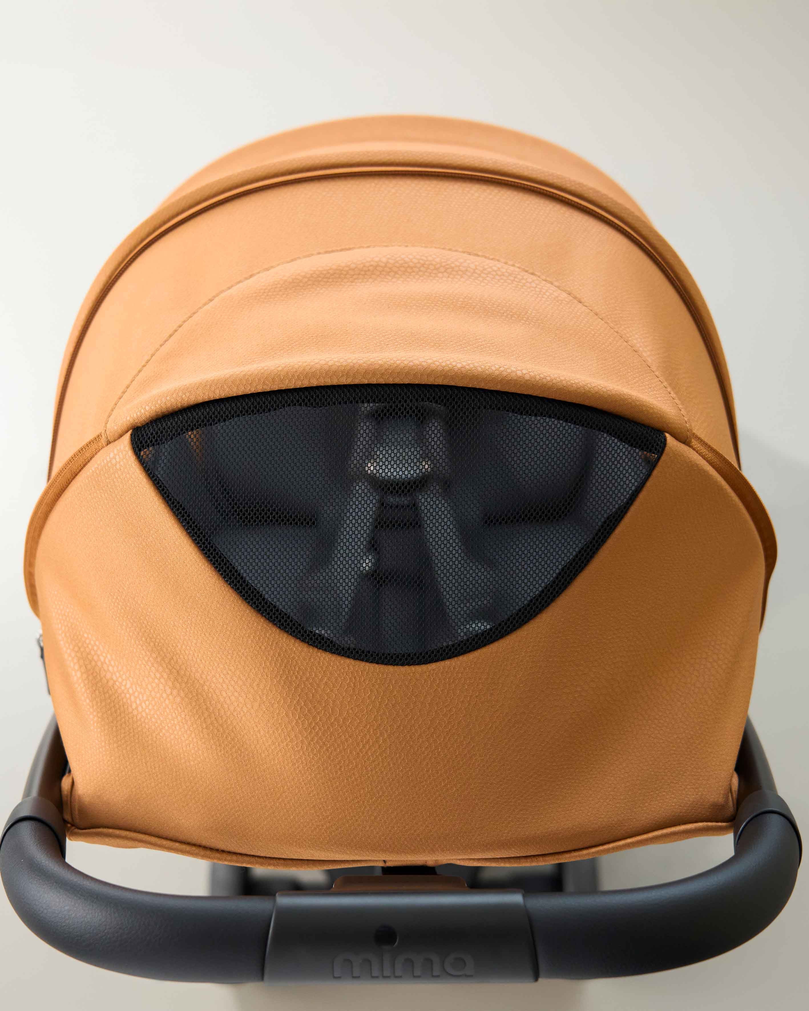 top view of open canopy ventilation window on mima miro stroller in mocha