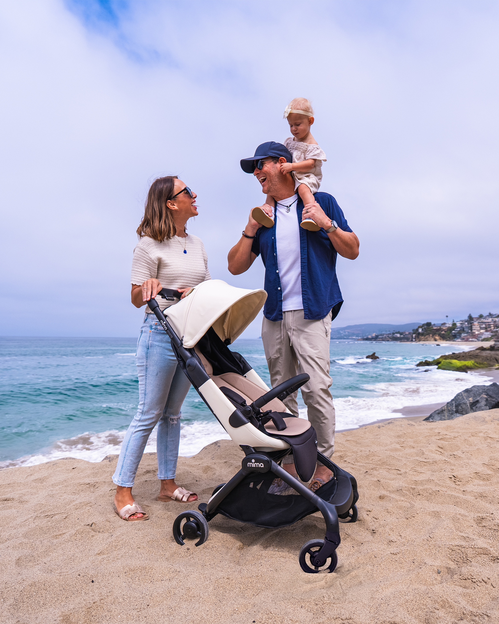 Family spending a day in the beach with the mima miro white stroller