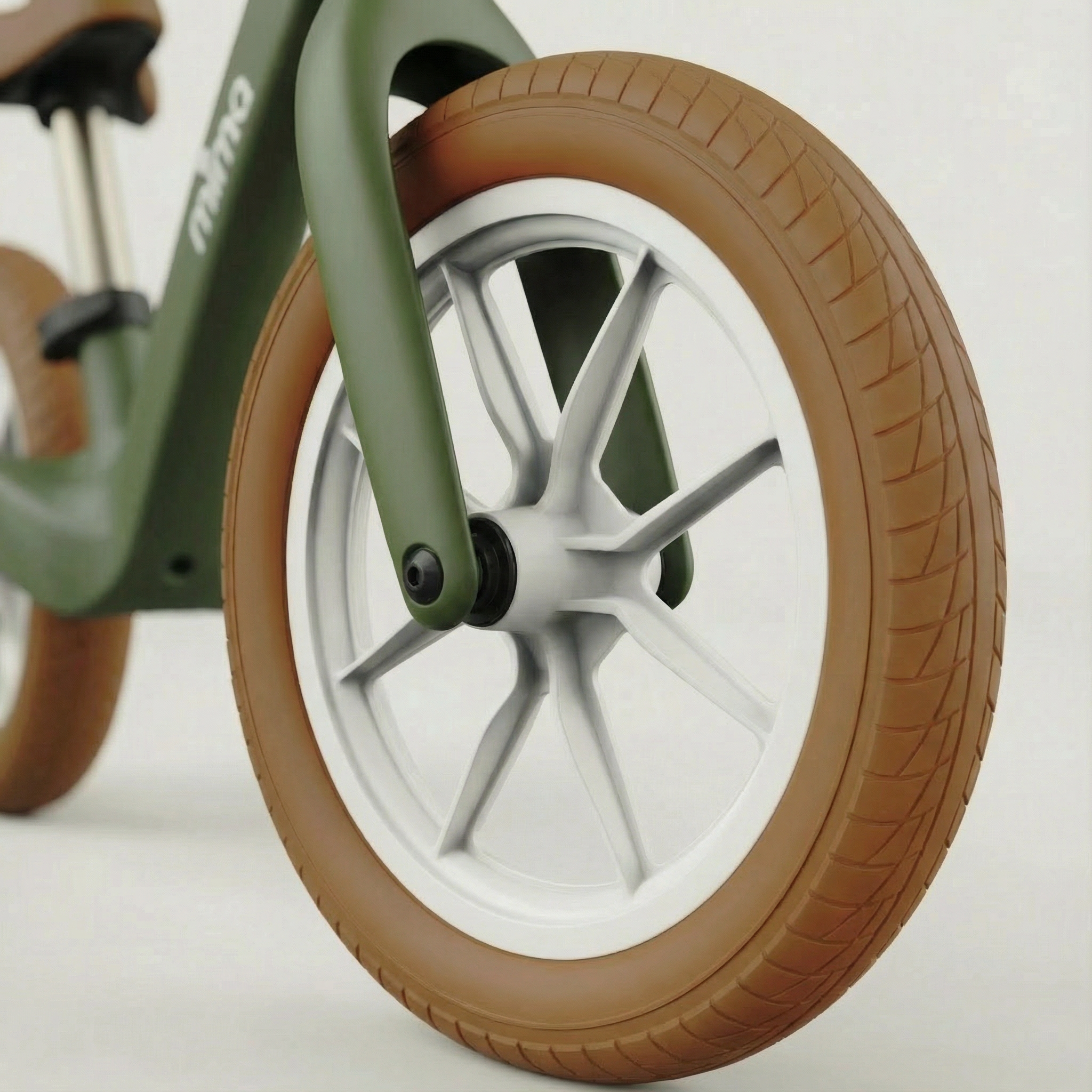 close up of the front wheel on mima zoom lite balance bike in green