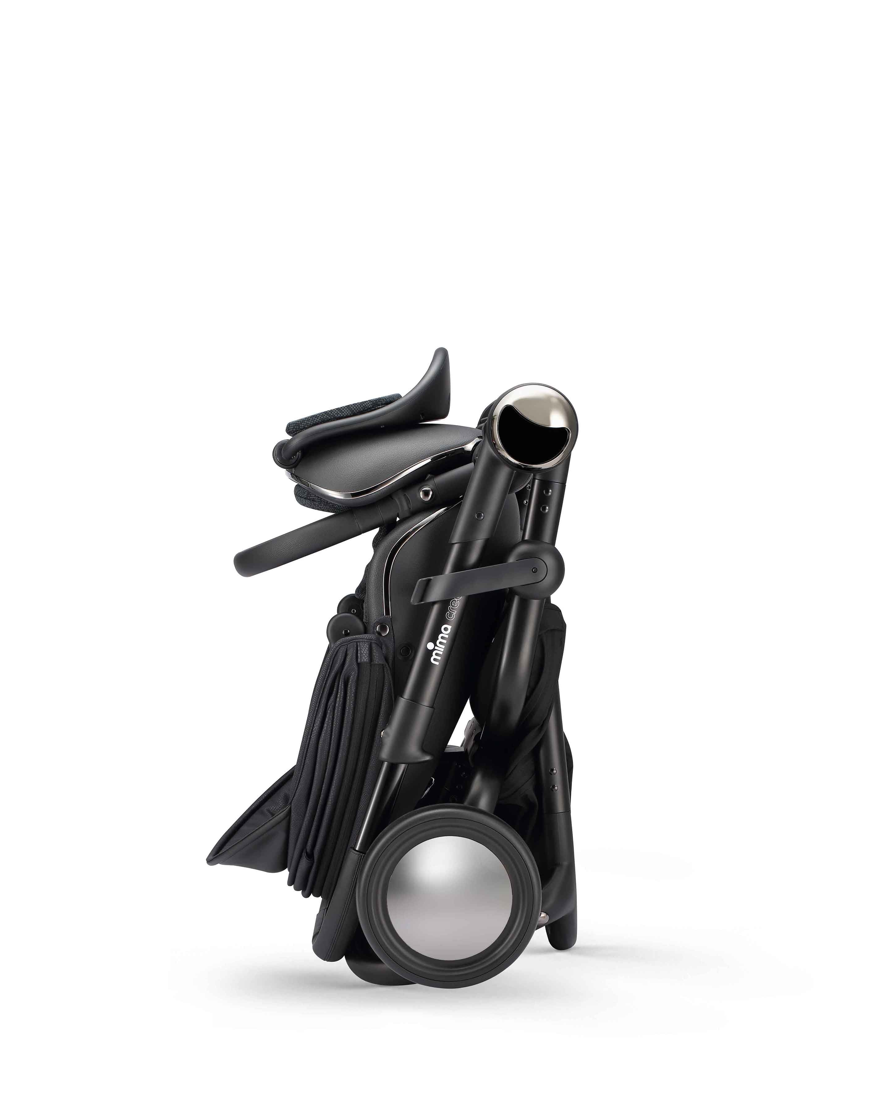 mima creo stroller in black in folded position, side view