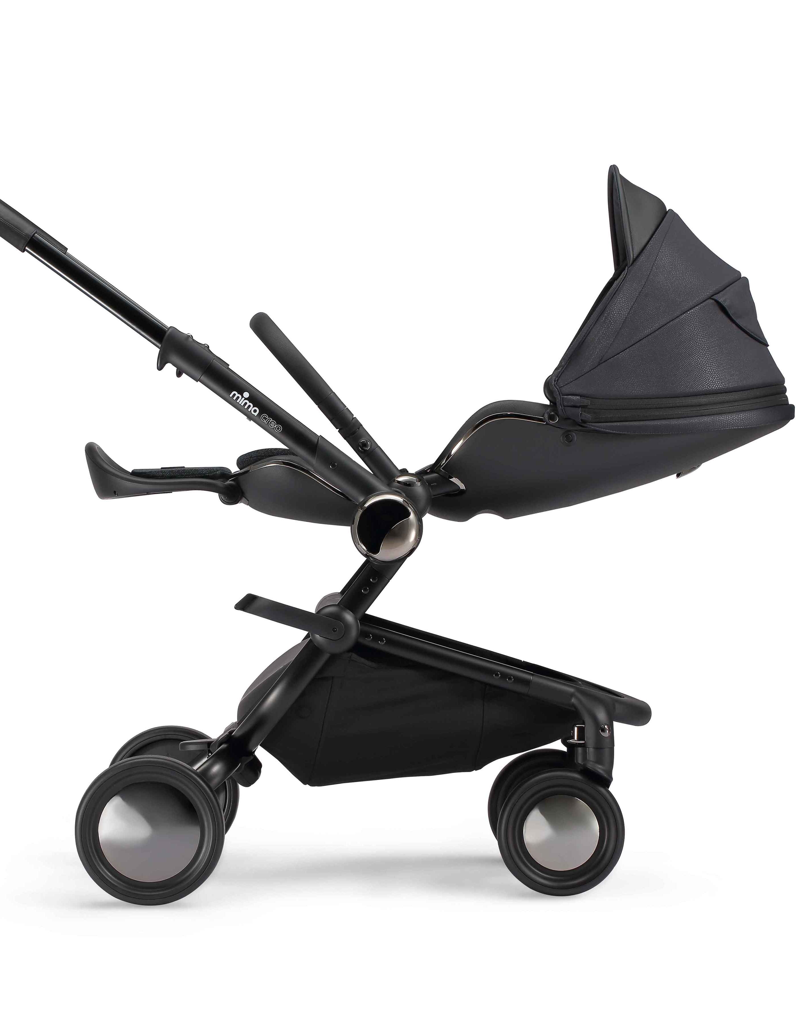 side view of parent facing fully reclined mima creo compact stroller in black
