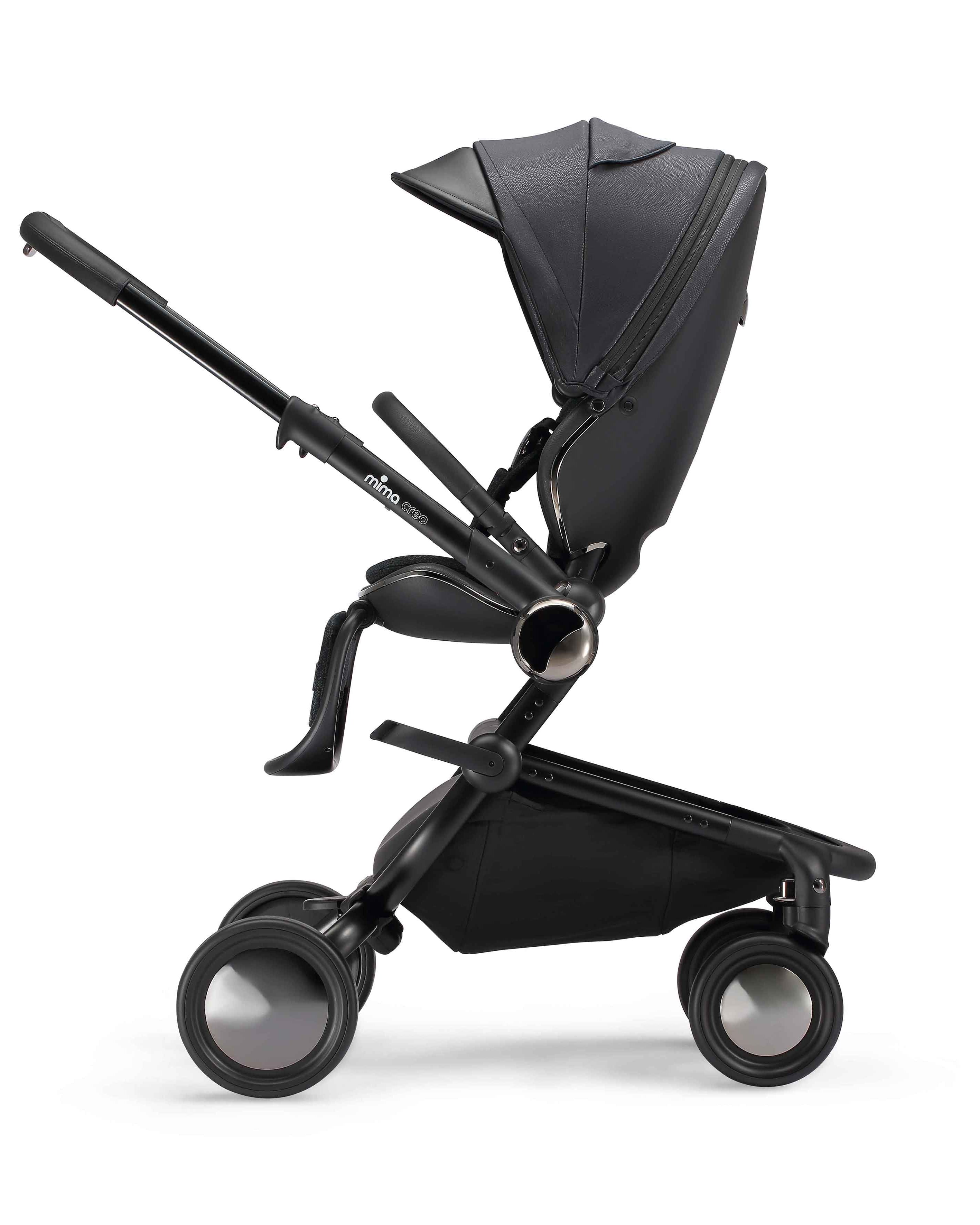 parent facing mima creo stroller in black with upright seat, side view.