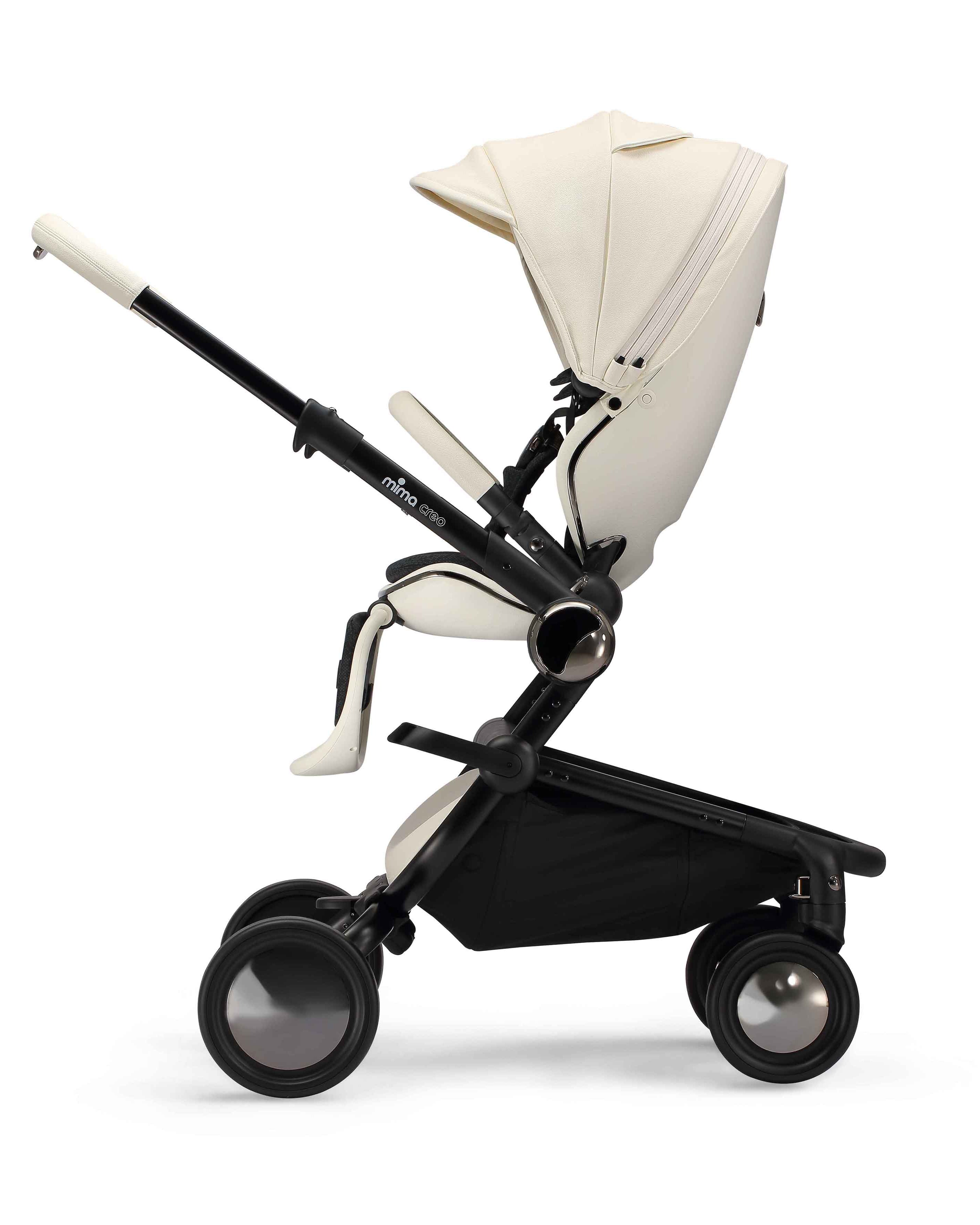 side view of parent facing fully reclined mima creo compact stroller in white