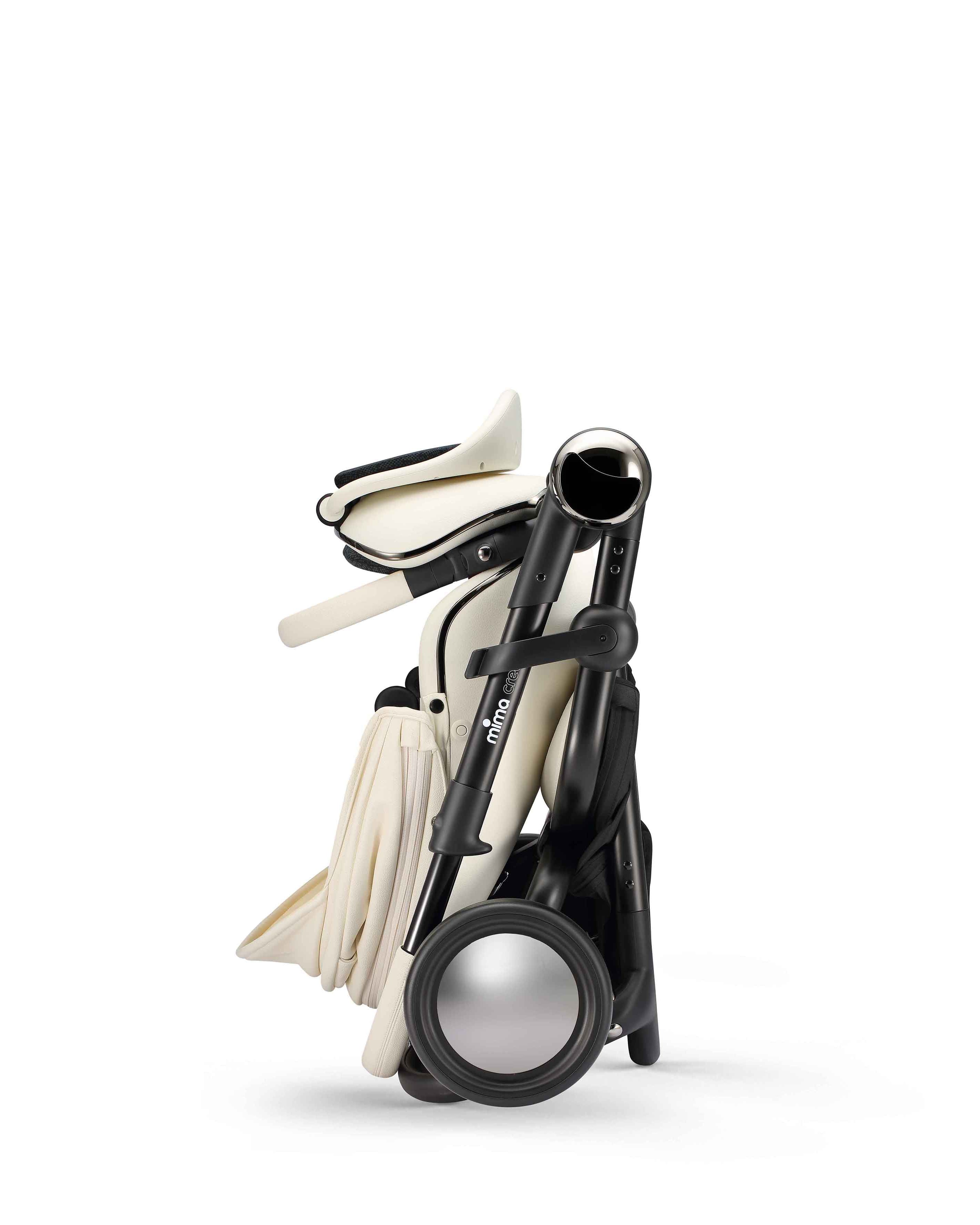 mima creo stroller in white in folded position, side view