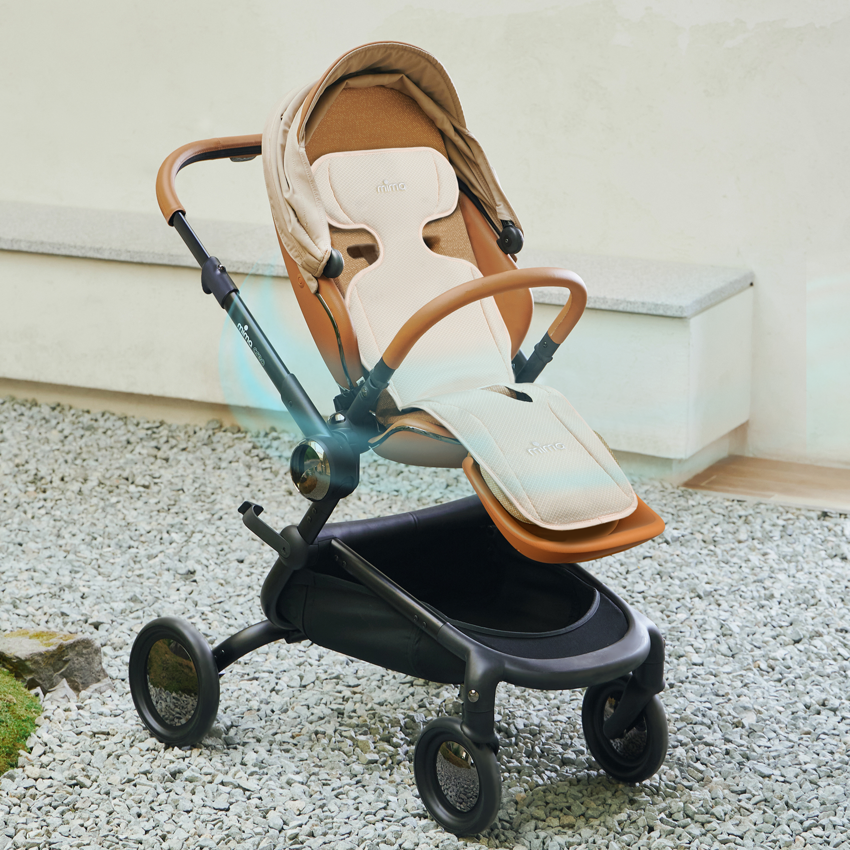 mima flo donut in beige installed on a creo stroller outdoors on gravel