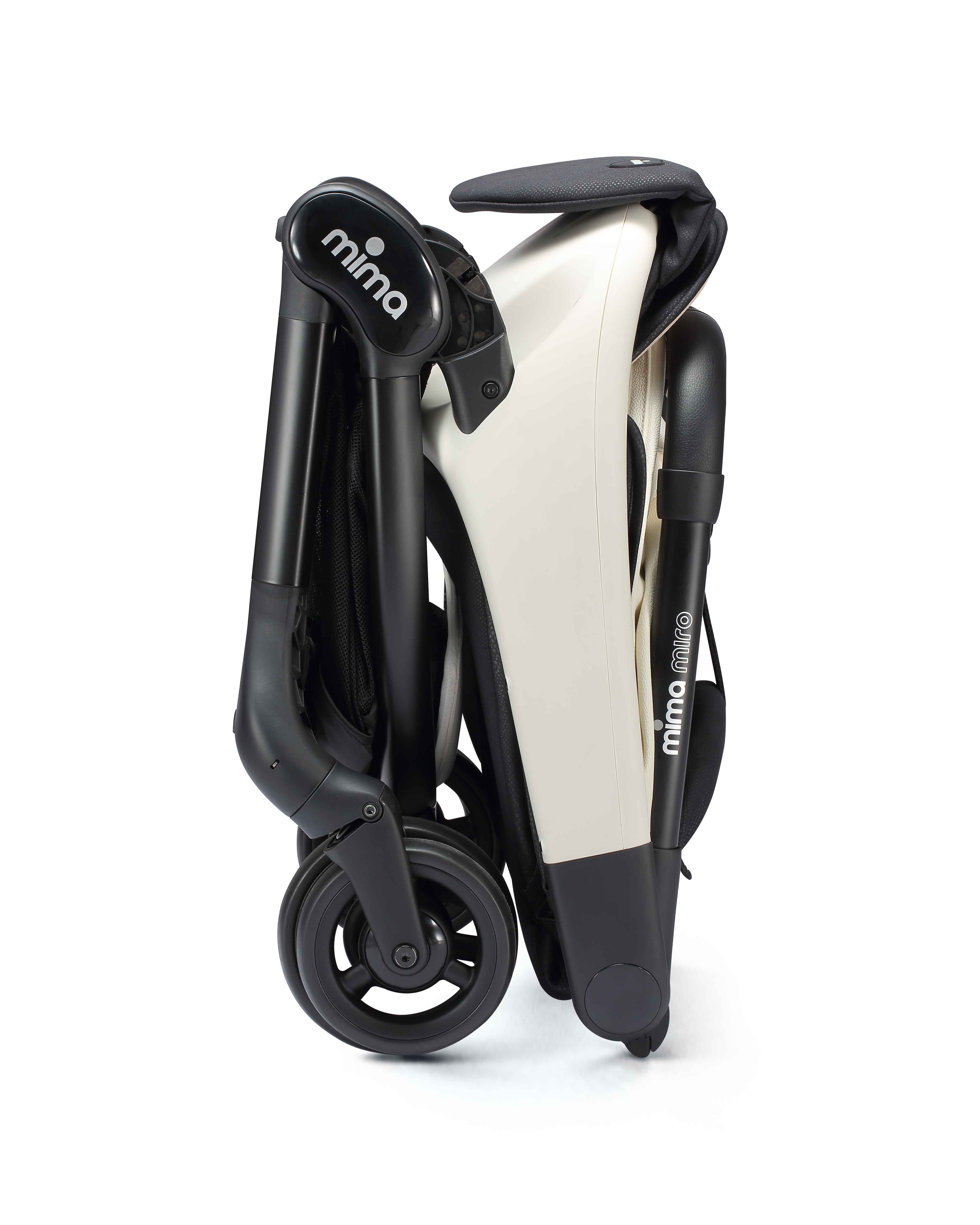 miro compact stroller in white, vertically folded with shadow, side view