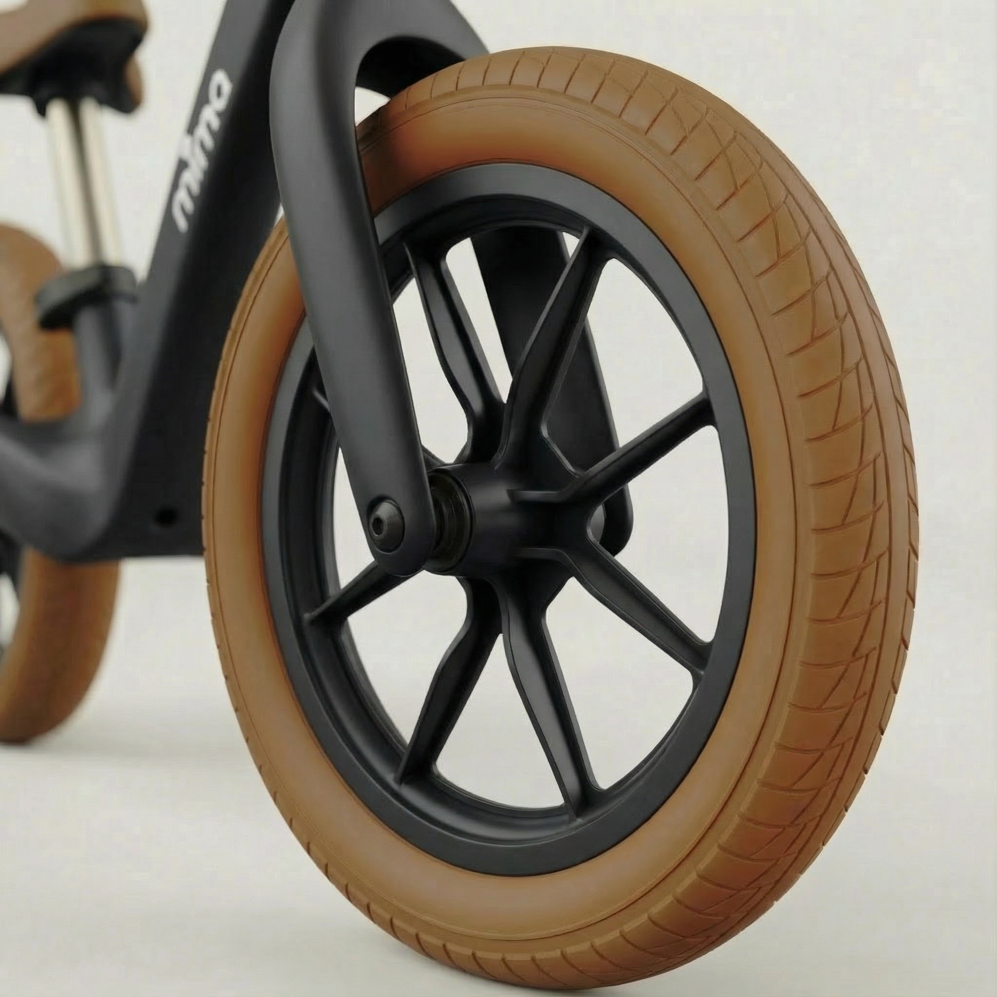 close up of the front wheel on mima zoom lite balance bike in black